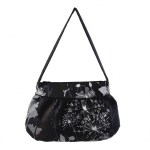 Musta pohjaväri vaaleat kuviot laukku